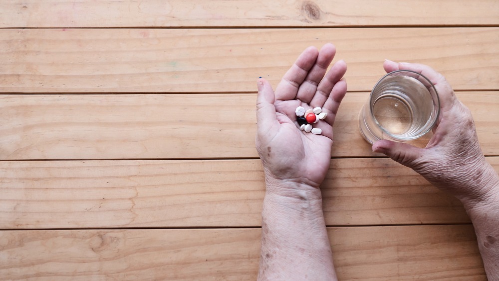 old lady prepare eat daily medicine pill