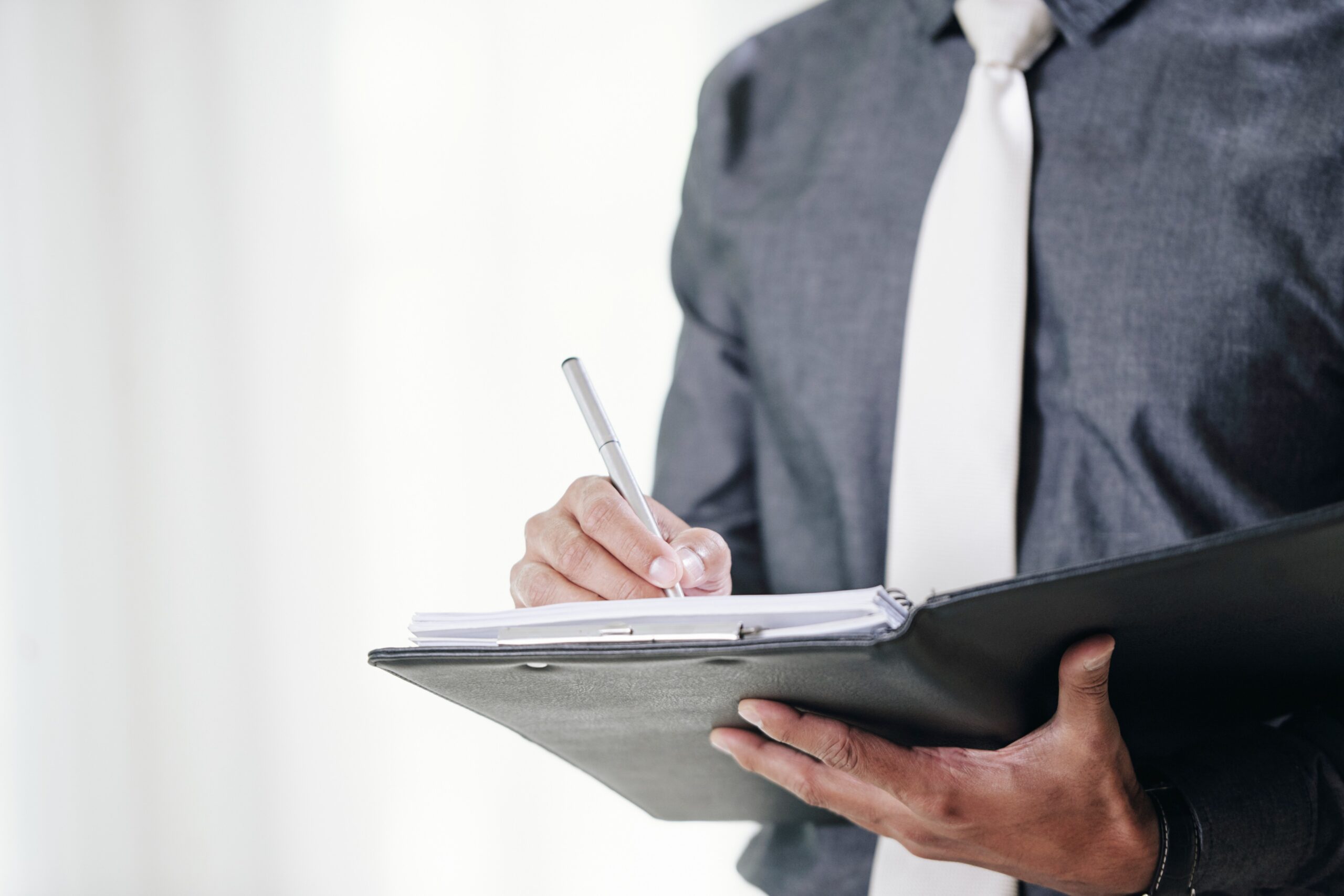 man holding up documents to evaluate
s