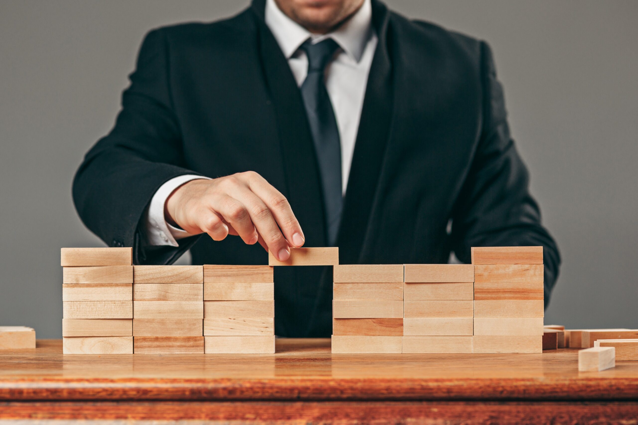 Man and wooden cubes on table