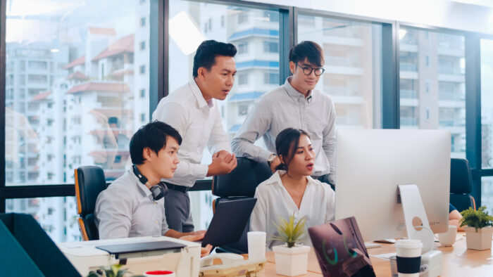 Collaborative process of multicultural businesspeople using computer presentation and communication meeting brainstorming ideas about project colleagues working plan success strategy in modern office.