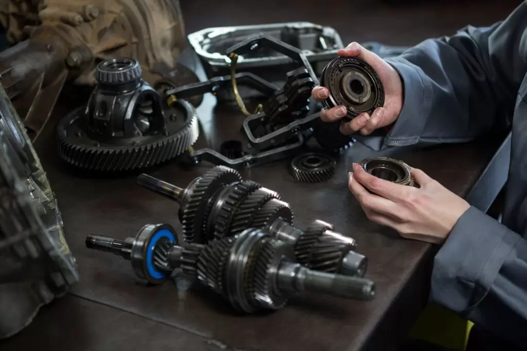 female mechanic holding spare parts car min 1024x683 2