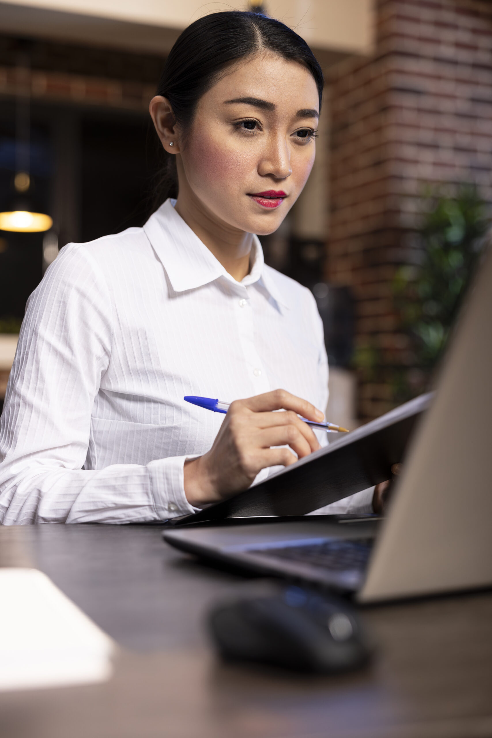 Entrepreneur using laptop and clipboard