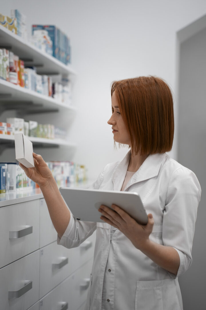 female pharmacist working with tablet pharmacy