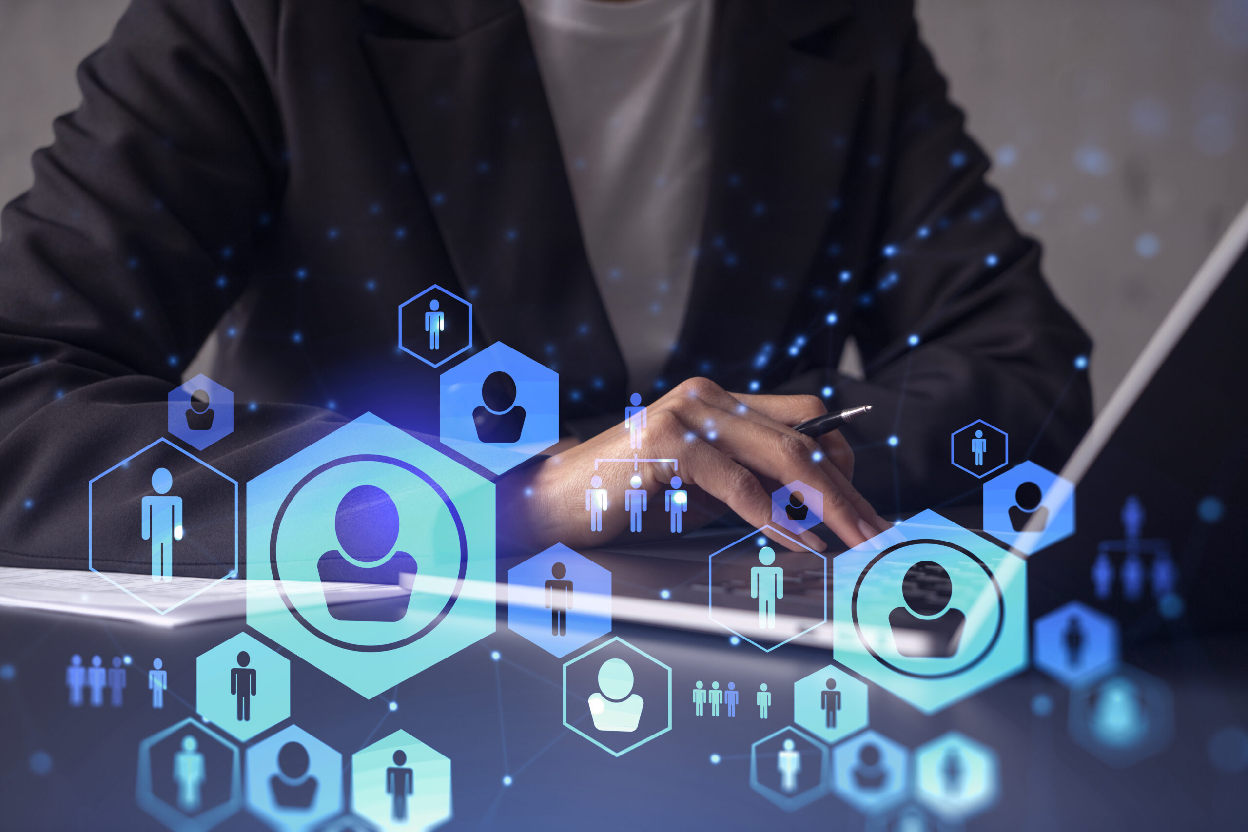 HR woman specialist is typing the keyboard in the internet to find the best candidates to create international network in recruitment process. Formal wear. Social media hologram icons.